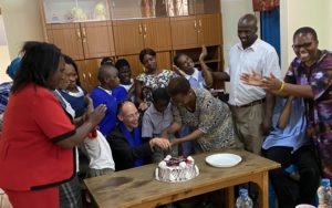 students and teachers of Kilimani celebrating the farewell cake
